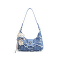 Blue denim hobo shoulder bag with brown strap, chain detail, and white teddy bear charm